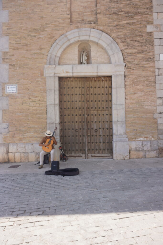 Guy playing the guitar near the church